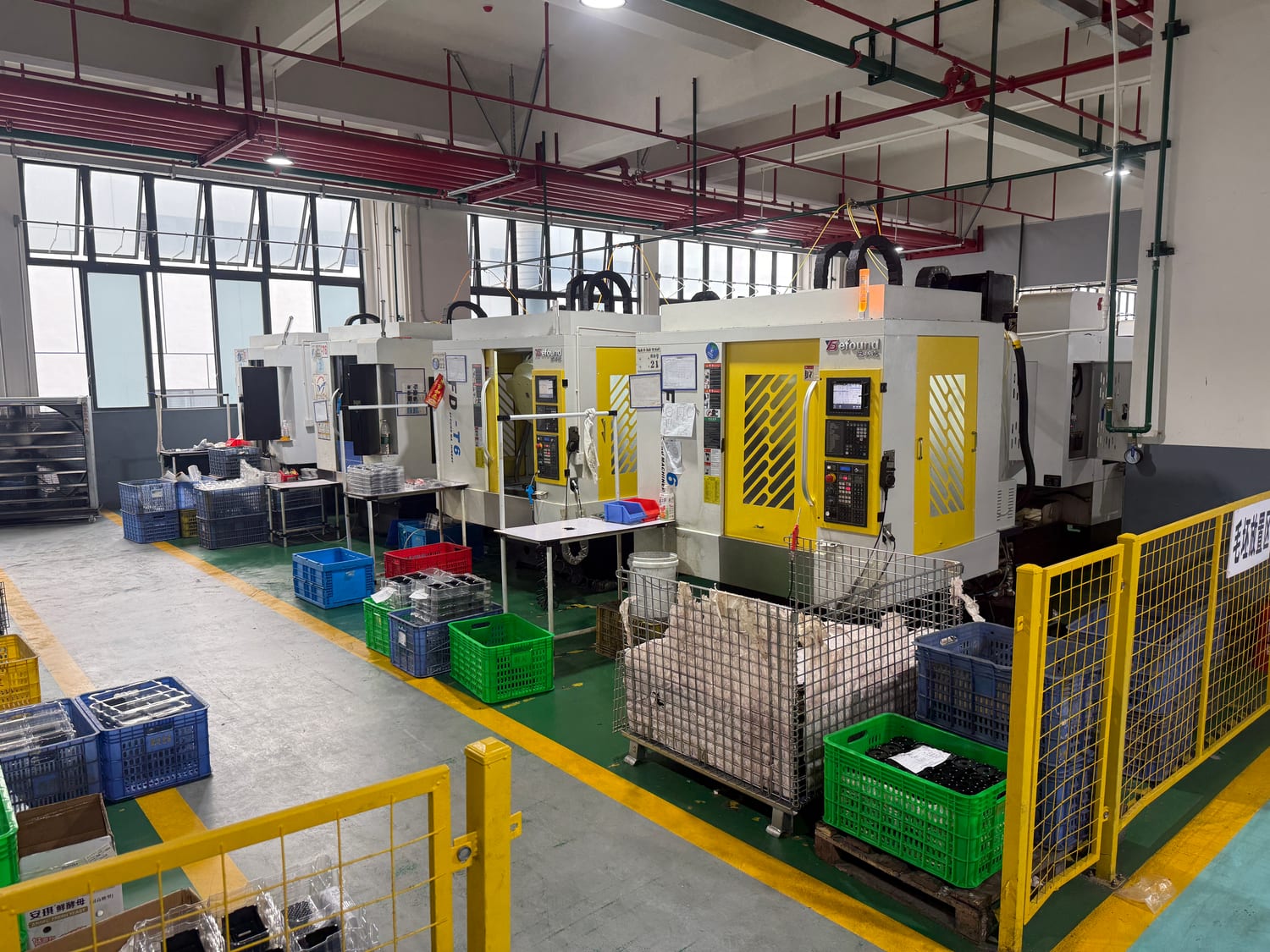 Row of vertical machining centers on a factory floor