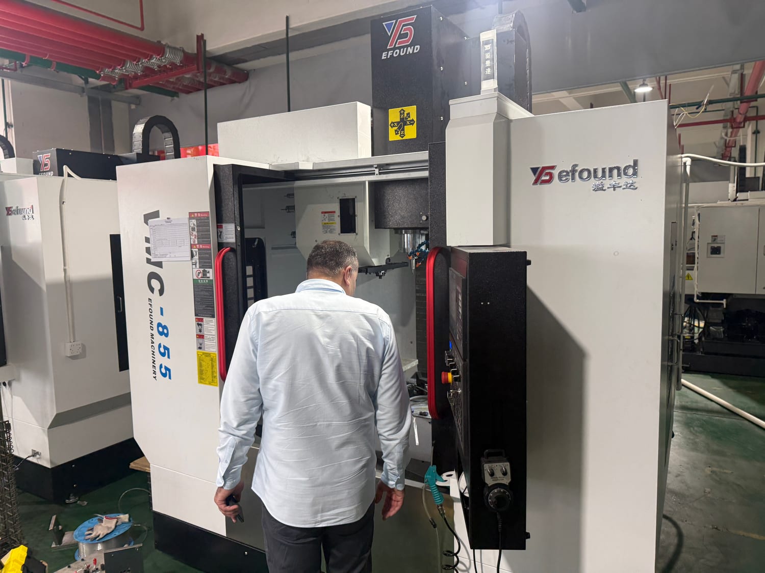 A Spektor team member on the line at an efound vertical machining center